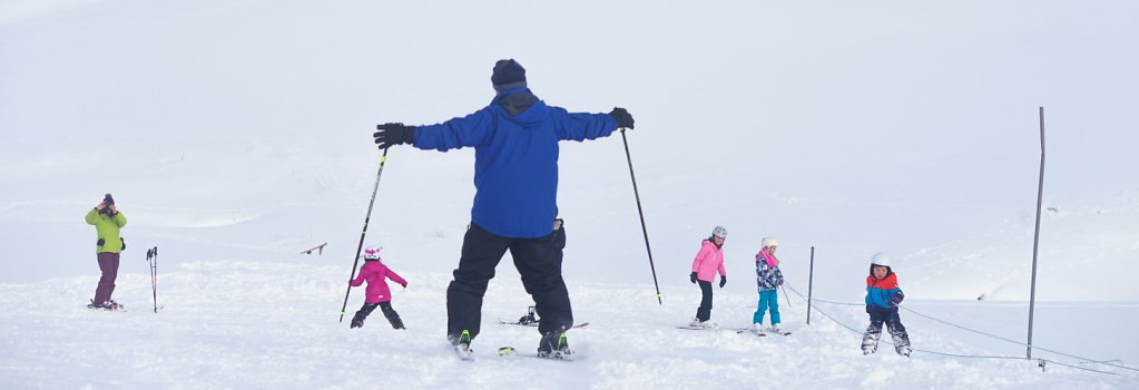 children-and-adults-learning-to-ski.jpg